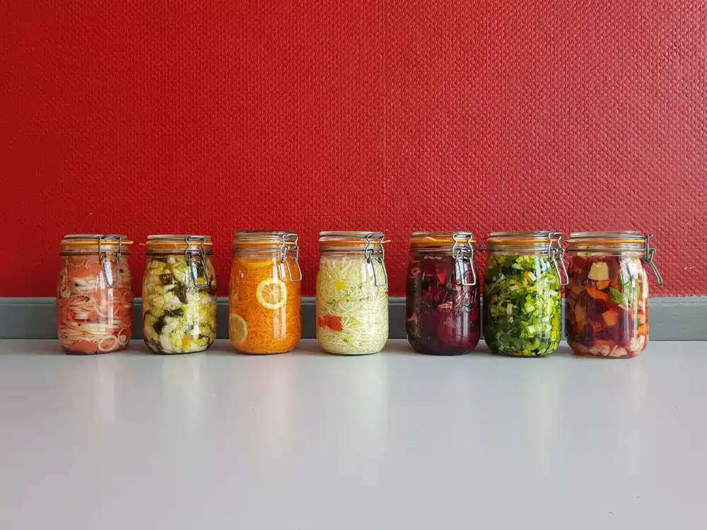 Jars of bright vegetables fermenting