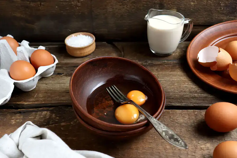 Fresh milk, cultures, and artisan salts arranged on a rustic table